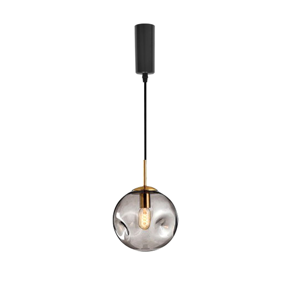 Modern pendant light with glass globe lampshade, gold accents, and black fixture for kitchen and gallery lighting.