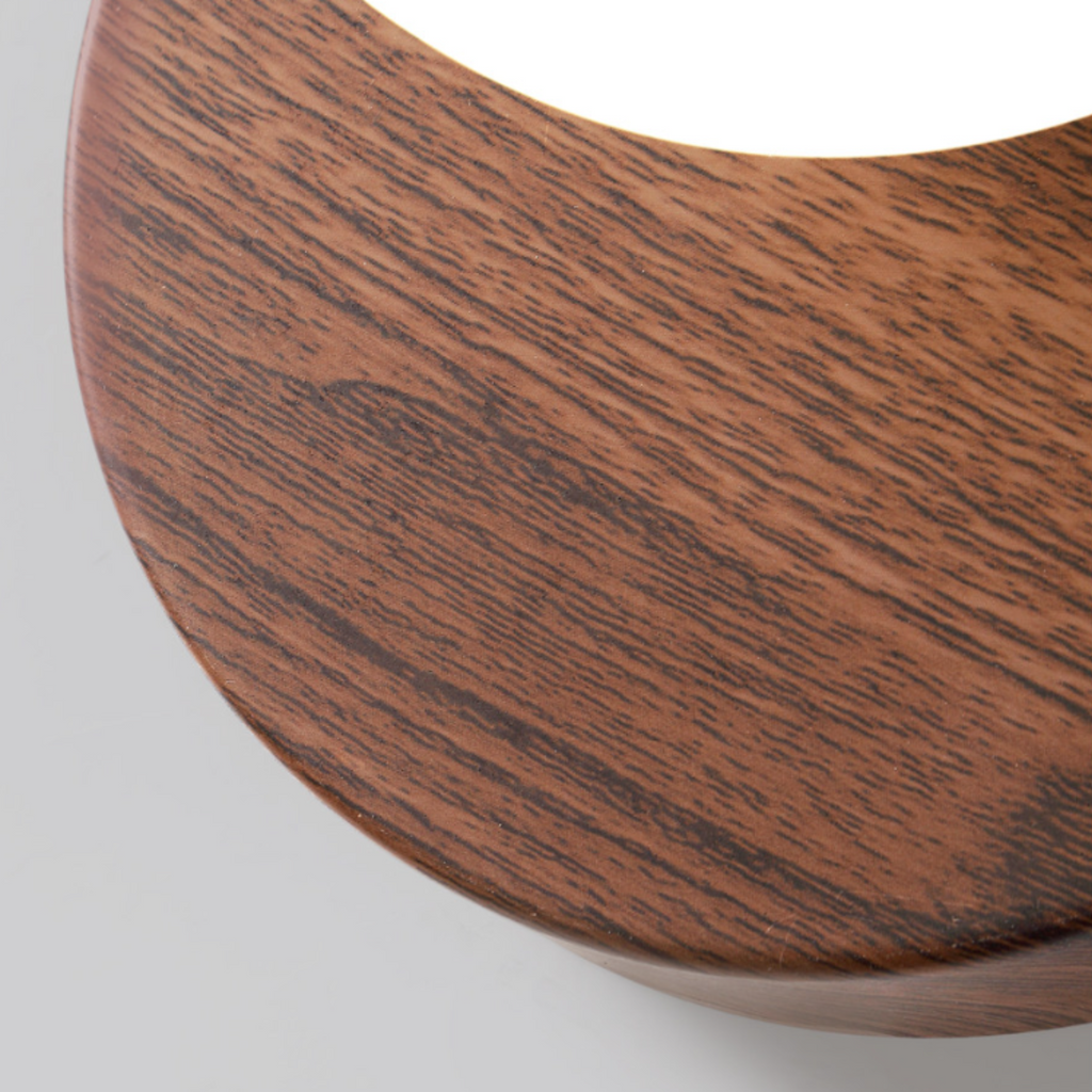 Close-up of high-quality natural walnut wood grain texture on the base of the LED wall sconce