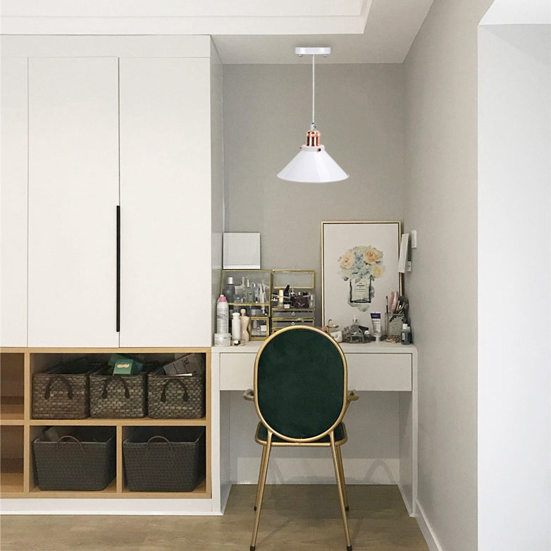 Battery-operated pendant light with adjustable cable and white cone shade, copper accents, illuminating a stylish vanity area