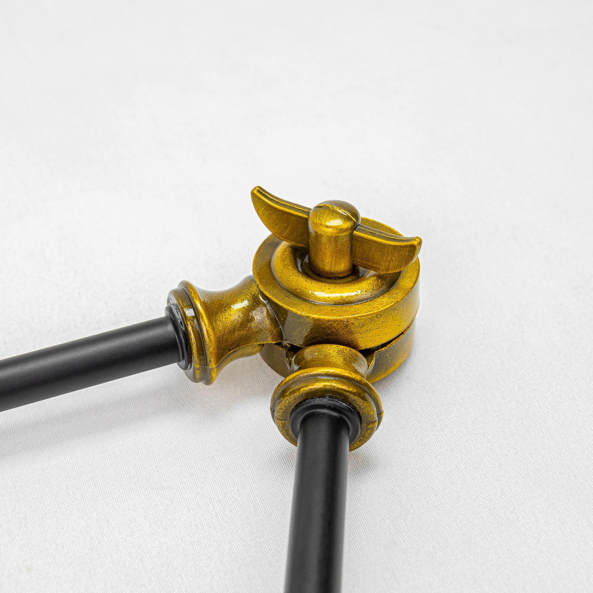 Adjustable gold bronze metal joint detail on vintage-style track lighting. Part of adjustable angle track lamp fixture.