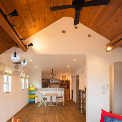 Sloped track light with glass globe pendants. Black metal fixture for inclined roofs. Modern lighting design for home.