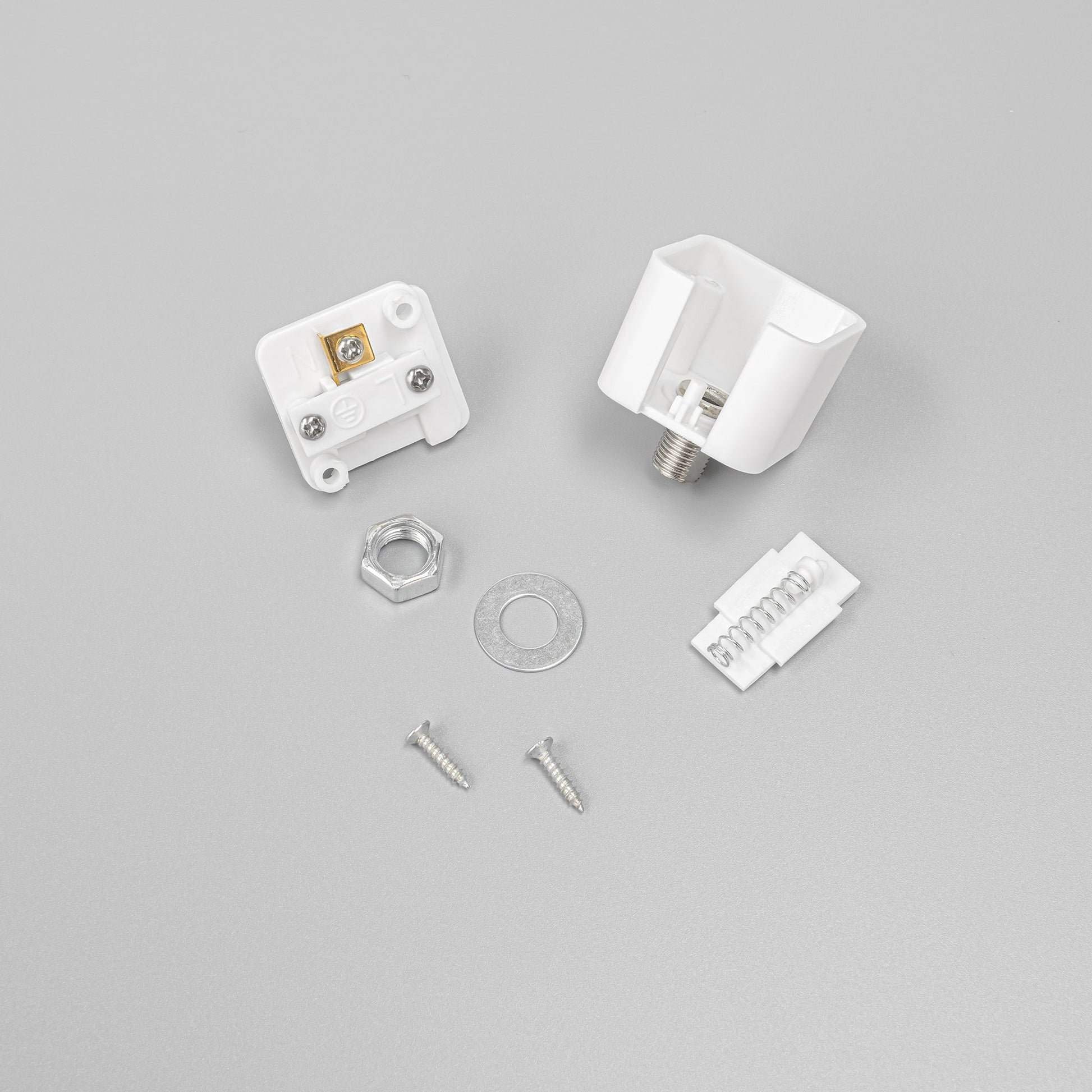 White Lightolier track adapter components: socket, screws, nut, and spring. For L system stage lighting DIY projects.