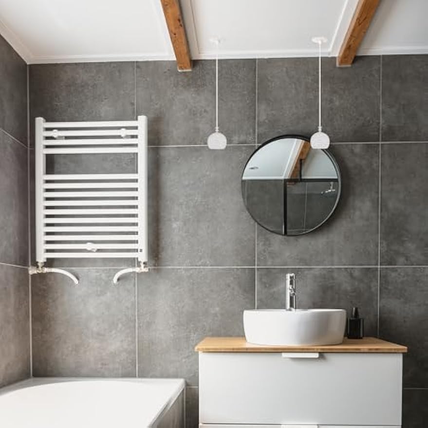 Modern bathroom with white pendant lights and crystal light fixtures, featuring white vanity and round mirror.