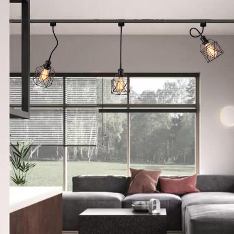 Black track lighting system with geometric pendant lights illuminating a modern living room.