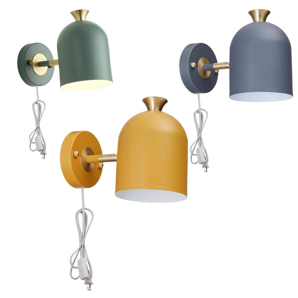 Mid-century modern plug-in wall sconces in green, steel blue, and yellow with brass accents.