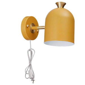 Mustard yellow mid-century modern wall sconce with brass accents, plug-in design for easy installation.