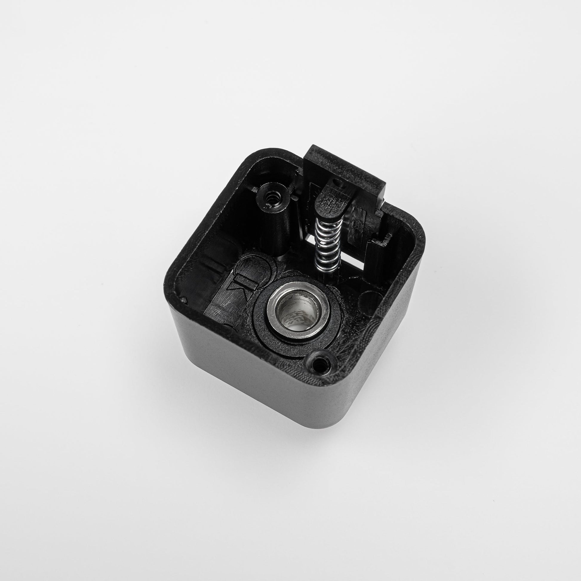 Black Lightolier track adapter fitting for L system stage lighting, with spring and metal details.