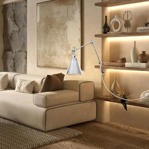 Silver Kiven clamp desk lamp illuminates modern living room, adjustable swing arm, plug-in cord, industrial design.