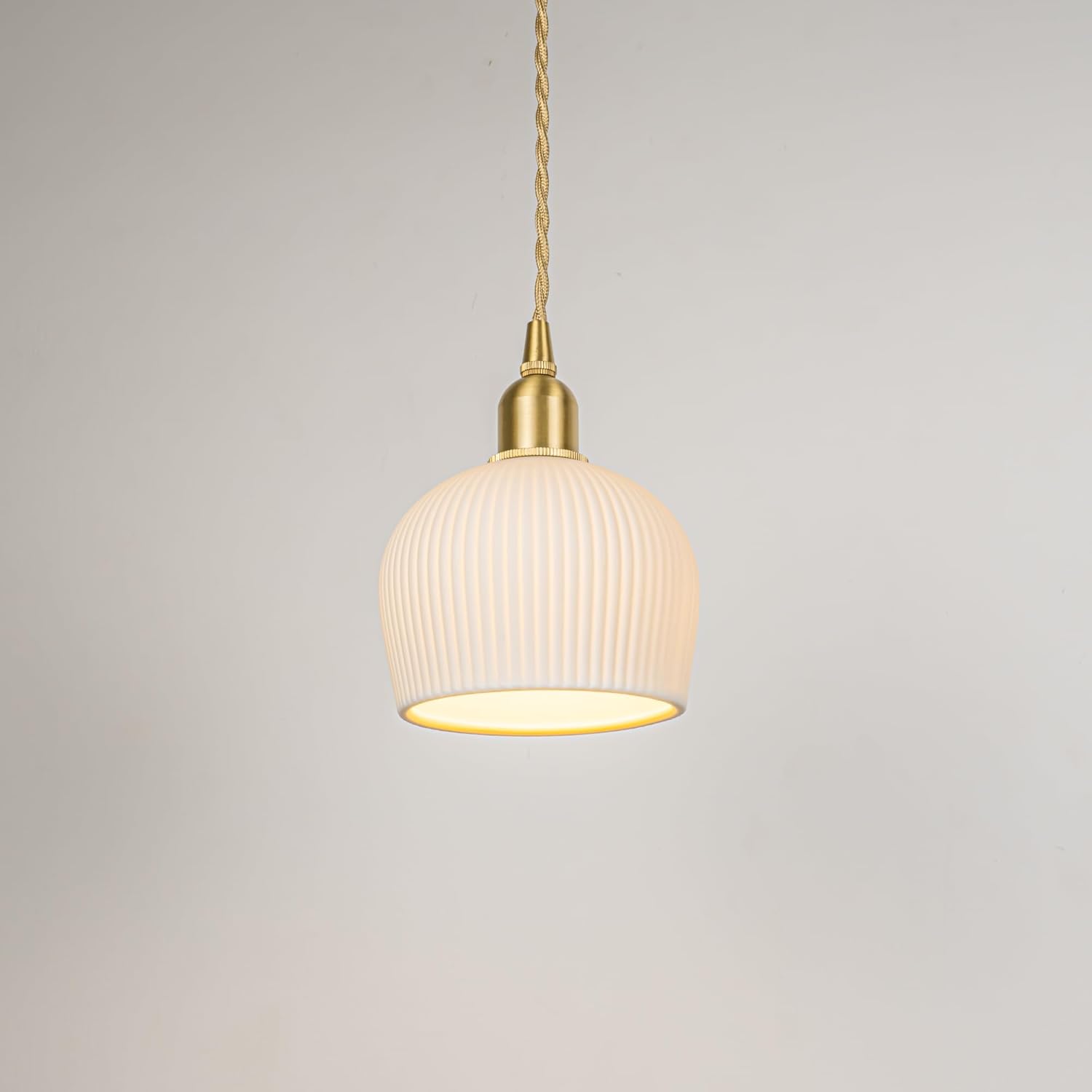 White ribbed ceramic pendant light with gold accents. Adjustable cord for sloped track lighting.
