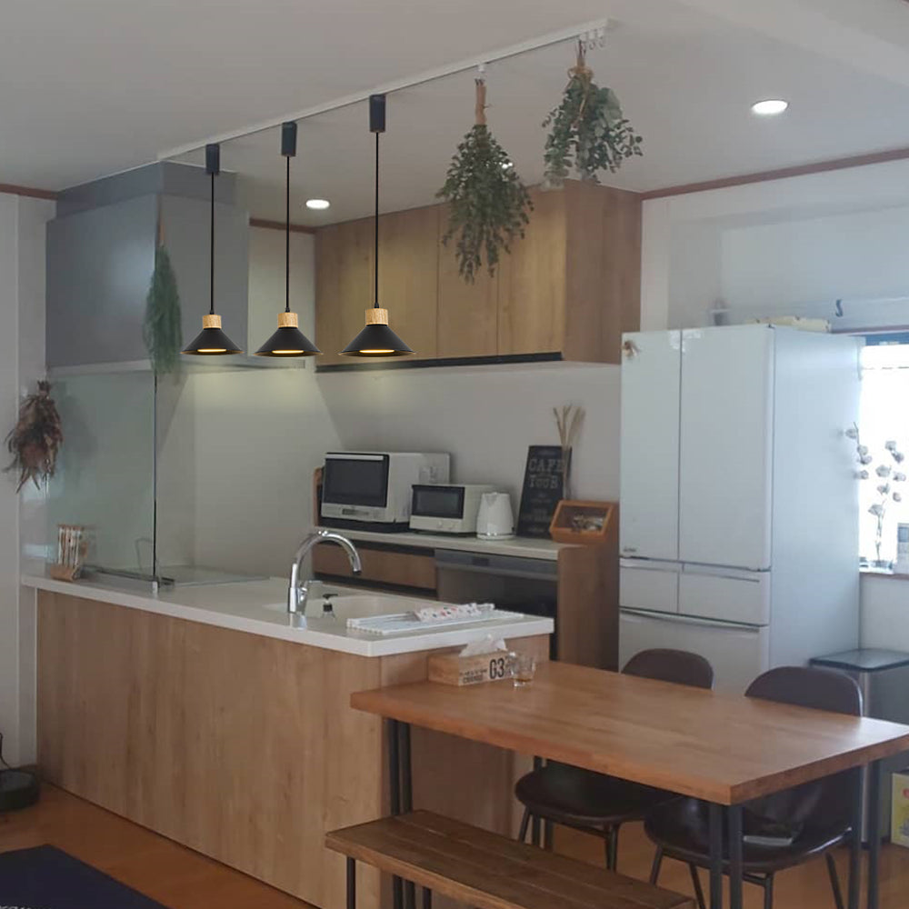 Black metal and wood pendant lights above kitchen island, adjustable track lighting.