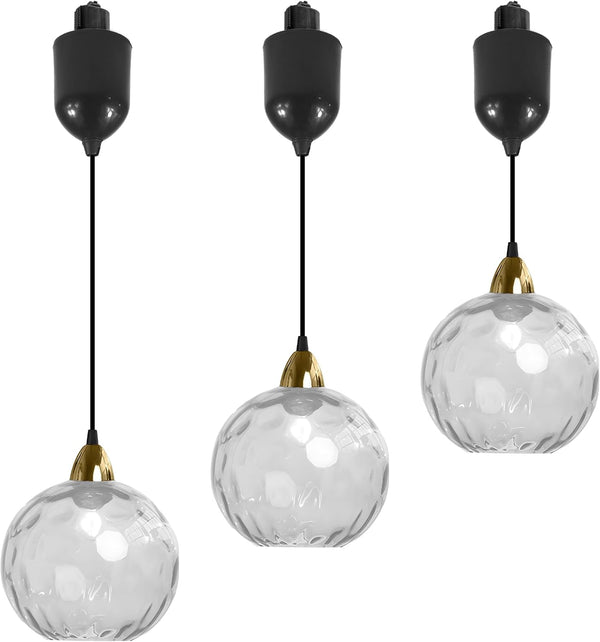 Three clear hammered glass Juno track pendants with black cord and adjustable height, ideal for kitchen or bar lighting.