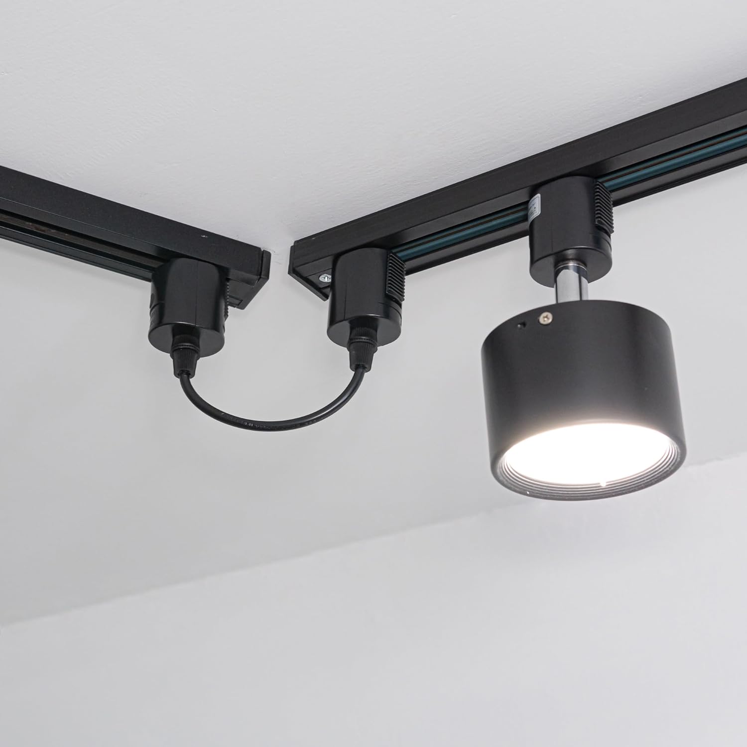Black track extension cord with track lighting, easy installation and providing power connection for track light.