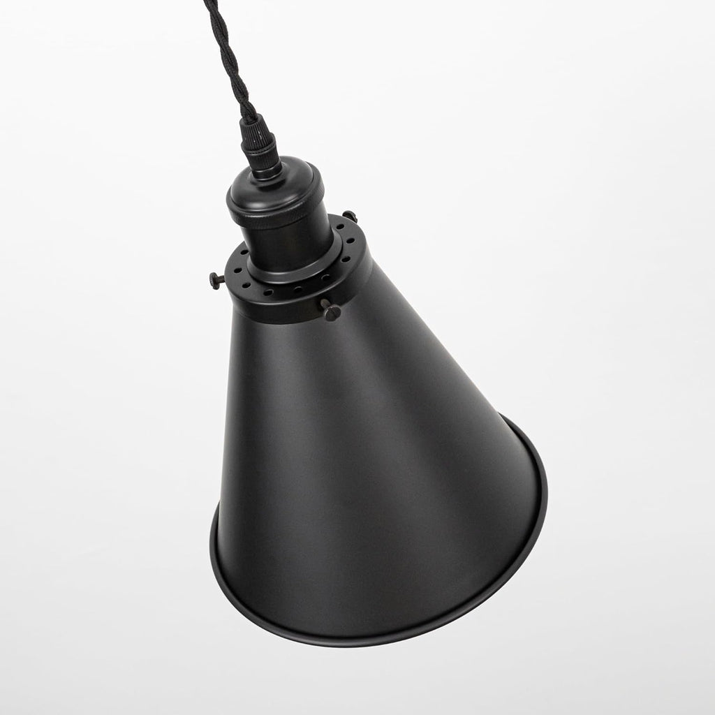 Black cone shade track lamp with adjustable cord. Vintage-style pendant lighting for home and commercial spaces.