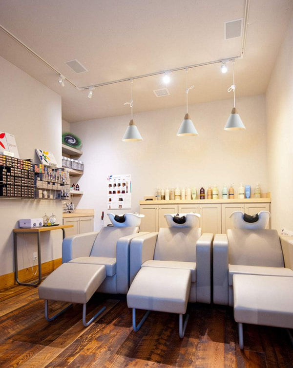White Scandinavian pendant track lighting over salon chairs, wood & aluminum track lights for dining room, modern design