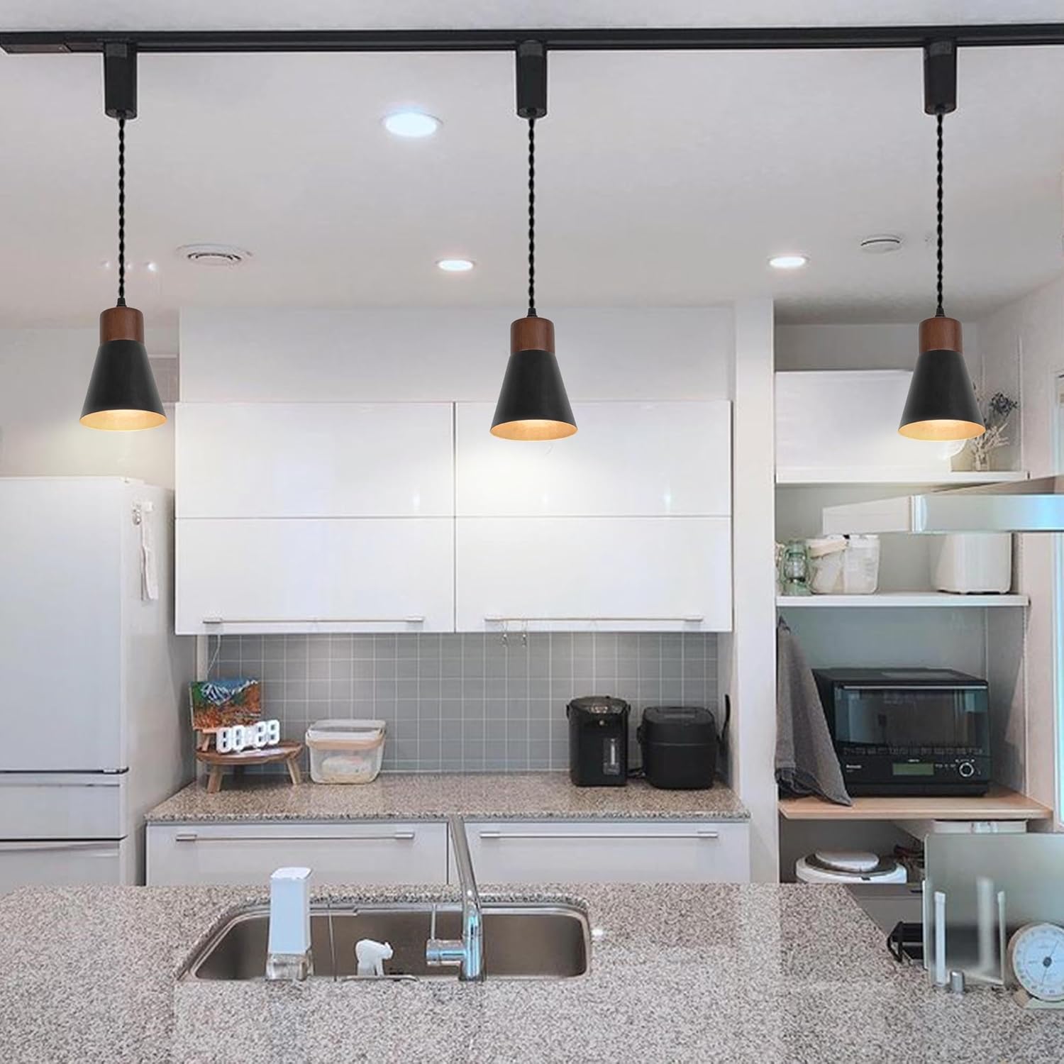 Retro track pendant lights with black shades and walnut base, kitchen lighting. Vintage style.