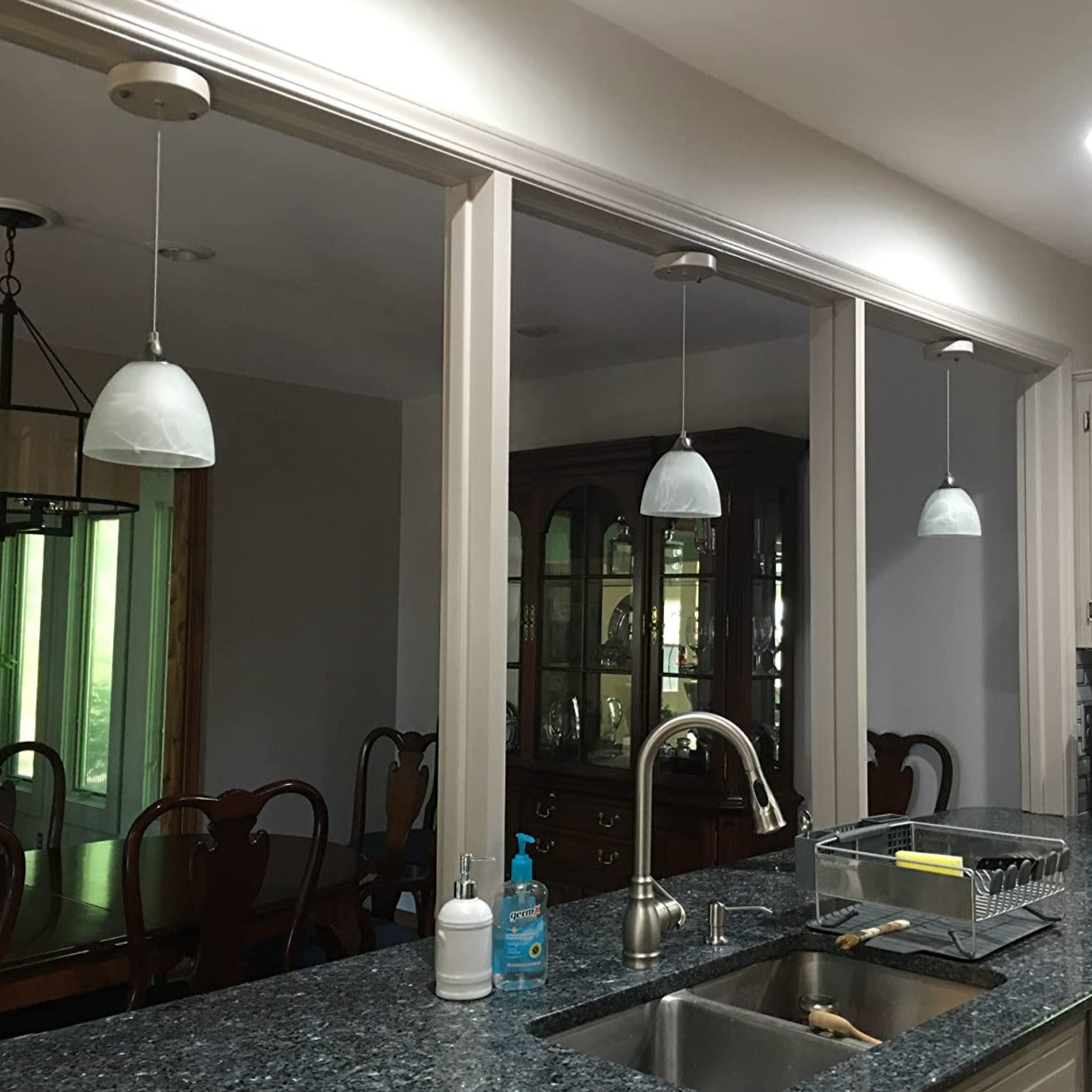 Battery-operated pendant lights over kitchen island with adjustable cable. Kiven Lighting wireless install.