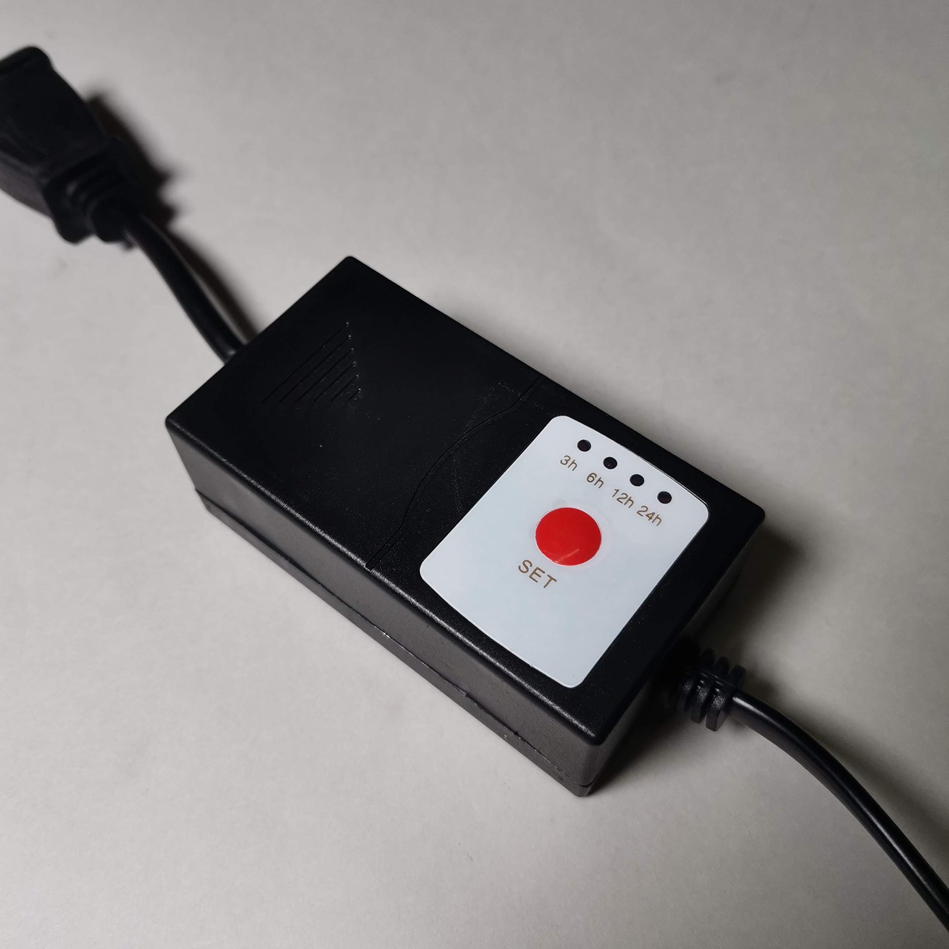 Black track lighting live end power kit with timer settings for track lighting.