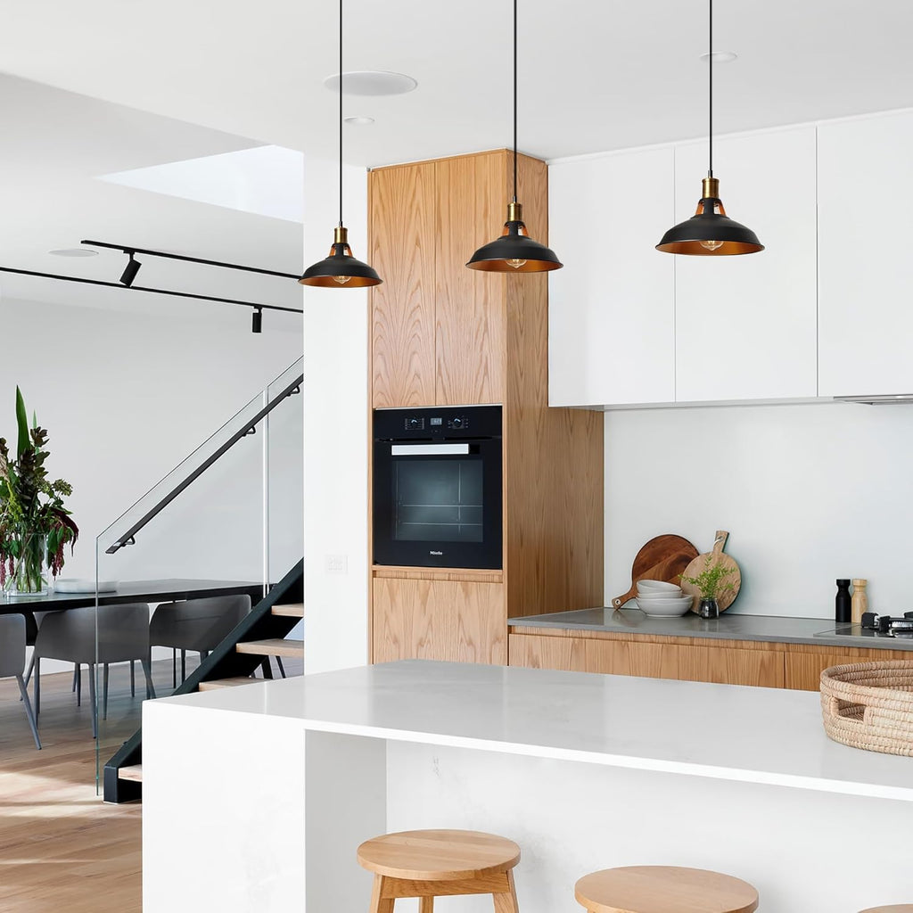 Gold macaron track pendant lights in modern kitchen, adjustable height, black and gold finish, stylish kitchen lighting.