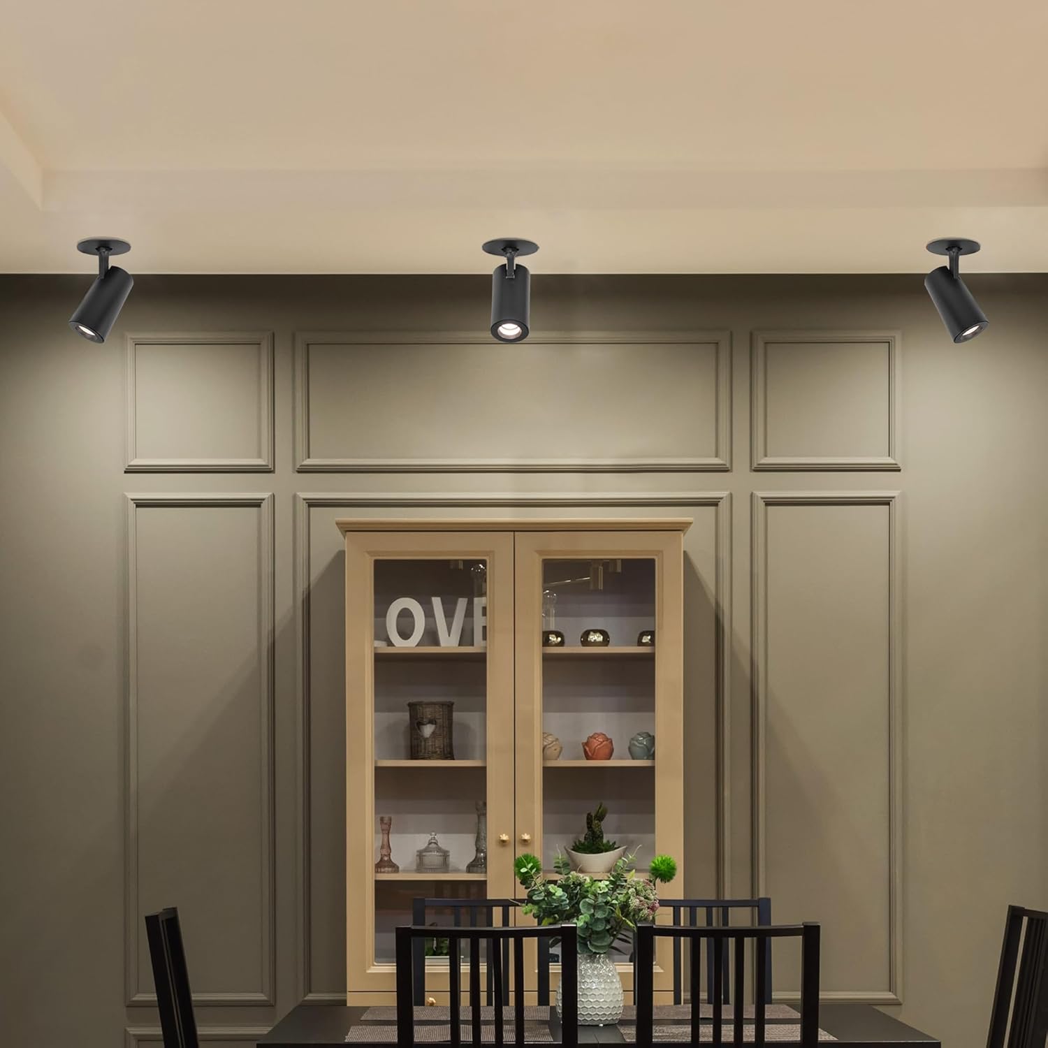 Black recessed LED ceiling spotlights by Kiven, adjustable for art picture lighting, modern dining room ambiance.