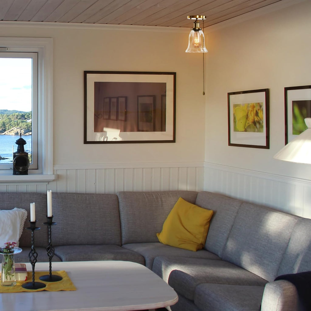 Gold RV Bell Ceiling Light, clear glass shade, vintage style, ideal for RV lighting, in a cozy living space.