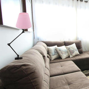 Kiven Pink Lampshade Reading Lamp, black adjustable arm, vintage bedside nightstand lamp for reading, placed on a brown sofa.