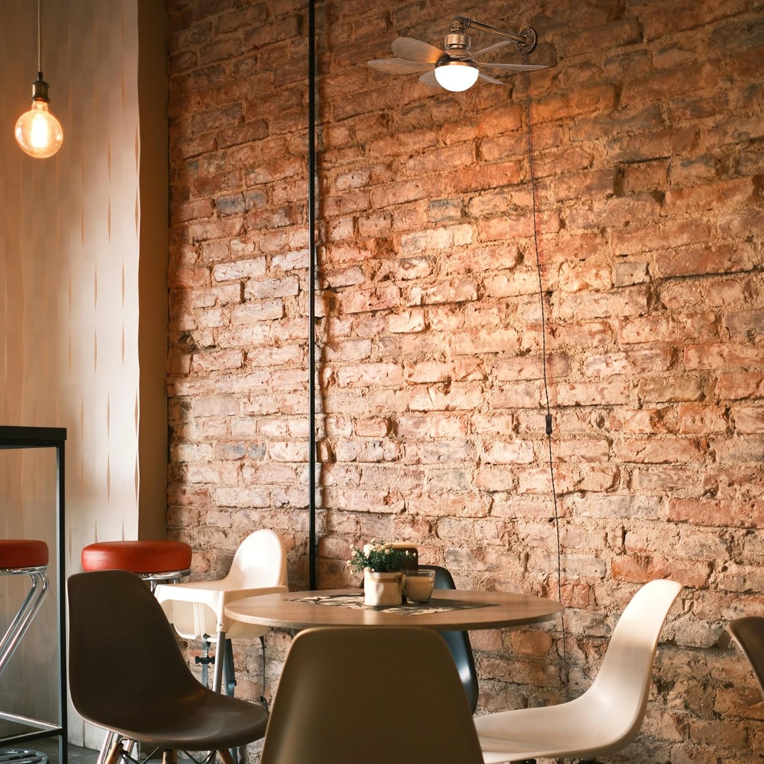 Retro wall mount fan with light in industrial cafe interior, rustic brick wall decor