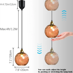 Adjustable orange glass Juno track pendant, with height adjustability, perfect for kitchen or bar lighting.