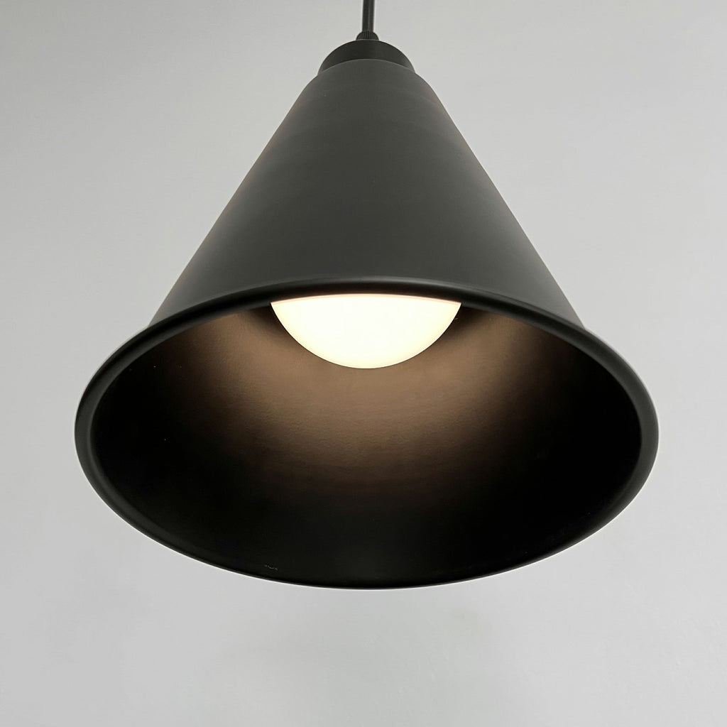 Black metal pendant light with adjustable cord, dimmable, smart LED bulb. Wireless design ideal for home lighting.