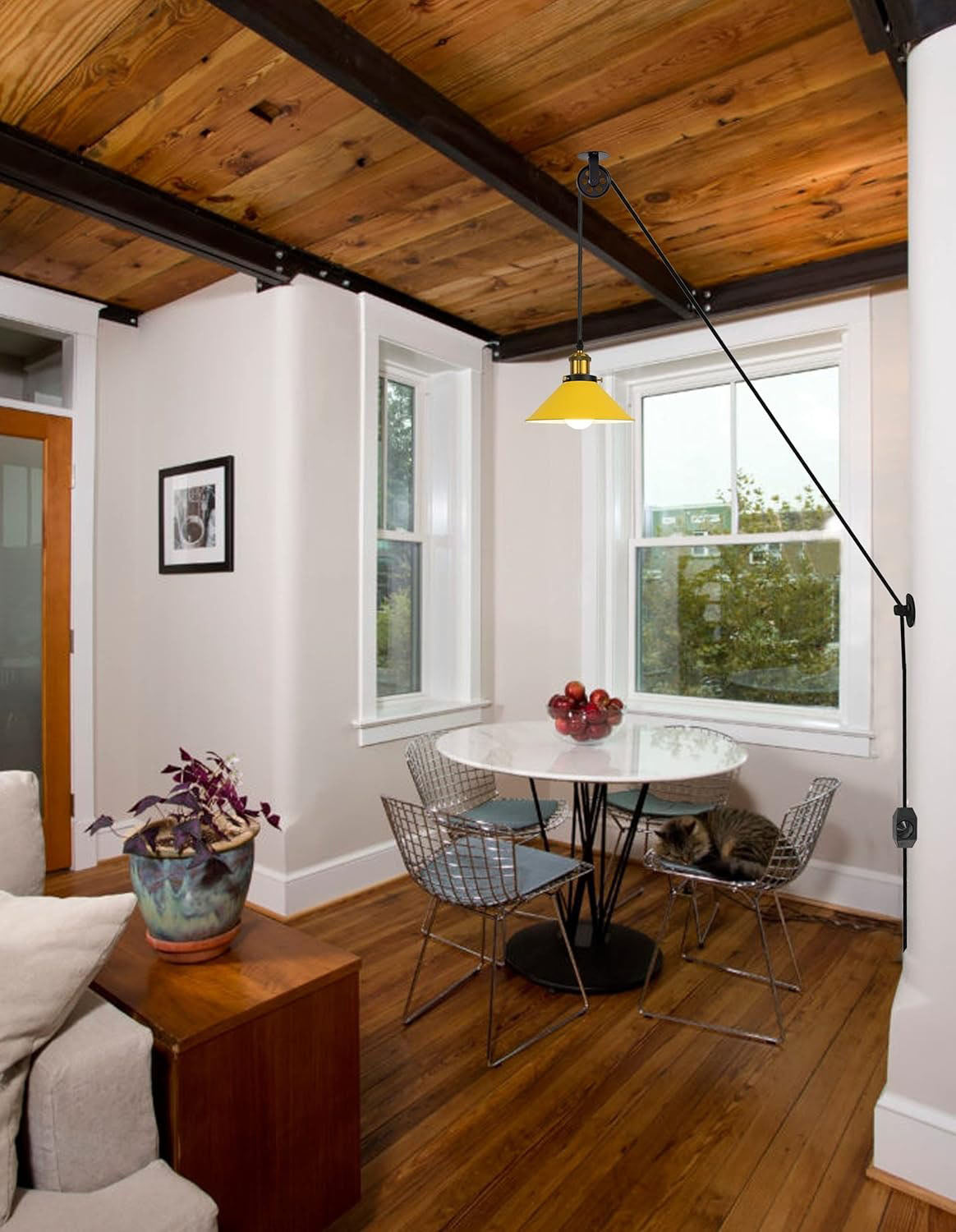 Industrial pulley pendant light with yellow shade over dining table, plug-in cord, Kiven Lighting