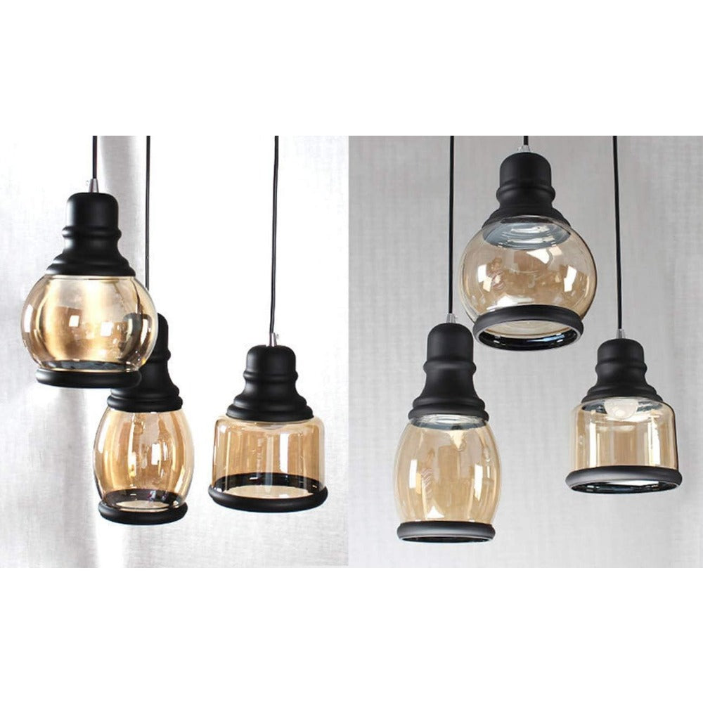 Amber glass pendant lights, vintage industrial style. Black metal accents for kitchen or dining room lighting.