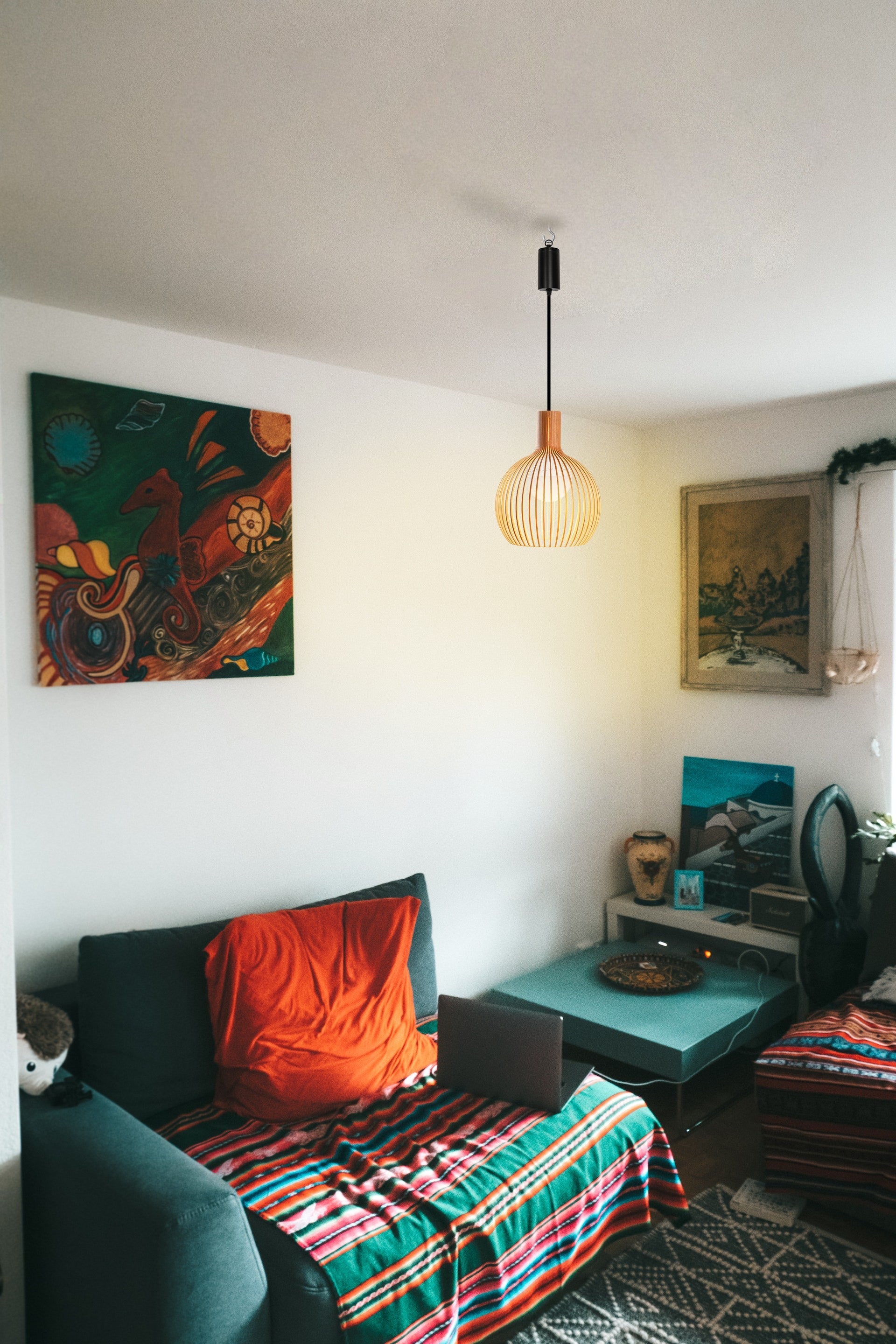 Battery-operated wood pendant light, minimalist design, illuminating a cozy living room setting